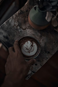 Directly above shot of person holding coffee cup