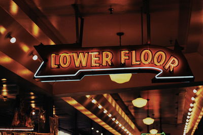 Low angle view of illuminated sign at restaurant