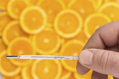 Close-up of hand holding yellow orange