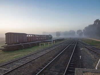 Train on railroad tracks against clear sky