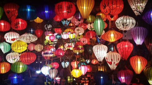 Low angle view of illuminated lanterns hanging at night