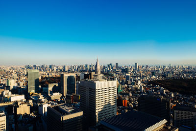 View of cityscape against blue sky