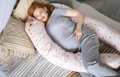 High angle view of woman lying on bed at home