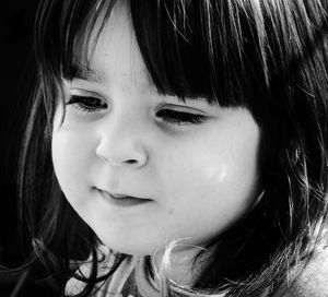 Close-up portrait of cute girl looking away