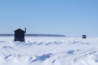 Scenic view of snow field against clear blue sky