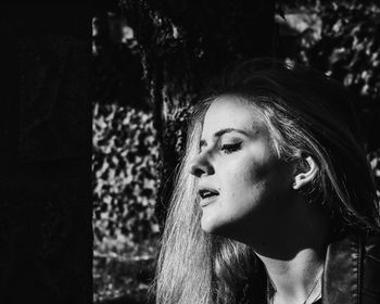 Portrait of young woman looking away outdoors