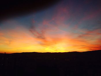 Silhouette landscape against scenic sky