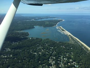 Aerial view of airplane wing over sea