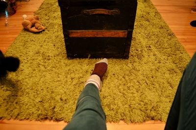 Low section of man wearing shoes on carpet