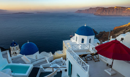 High angle view of buildings by sea against sky