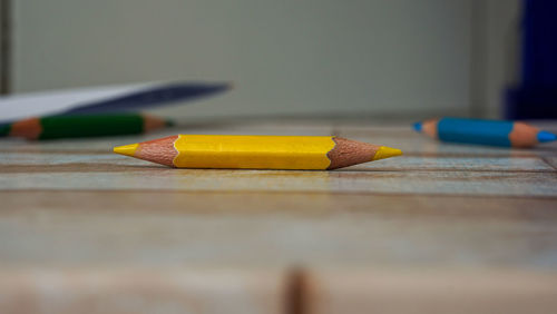 Close-up of yellow pencils on table