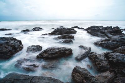 Scenic view of sea and rock against sky, lanta island thailand.