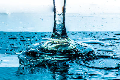 Close-up of water drop on blue surface