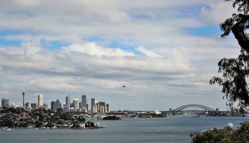 Bridge over sea with buildings in background