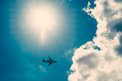 Low angle view of airplane flying against sky