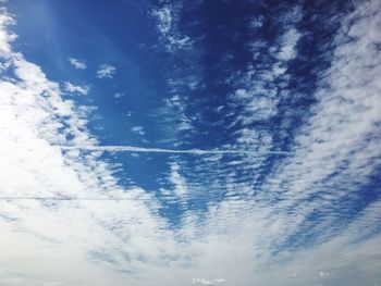 Low angle view of vapor trail in blue sky