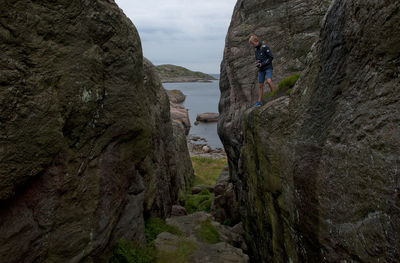 Full length of teenage boy standing on cliff