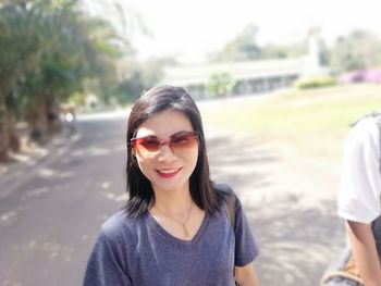 Portrait of smiling woman wearing sunglasses