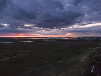 Scenic view of land against sky at sunset