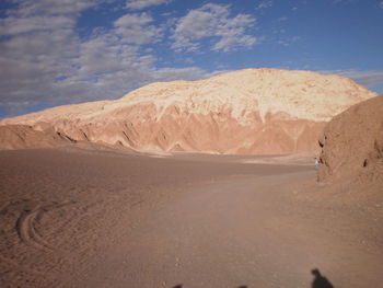 Sand dunes in desert against sky