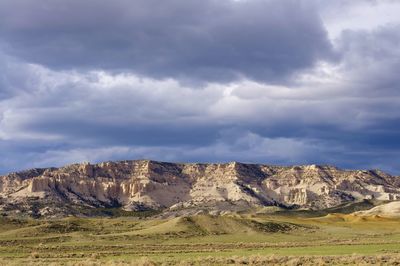 Scenic view of mountains against cloudy sky