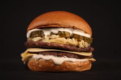 Close-up of burger against black background