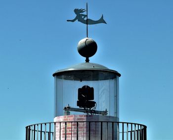 Low angle view of lamp post against clear blue sky