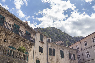 Low angle view of buildings in town against sky
