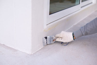 Man working on white wall