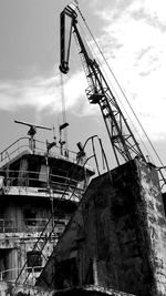 Low angle view of crane against sky