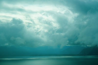 Scenic view of sea against storm clouds