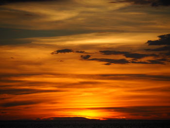 Scenic view of dramatic sky over sea during sunset