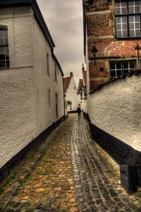 Footpath amidst buildings in city