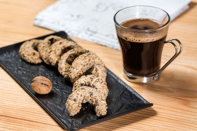 Coffee cup and cookies on table