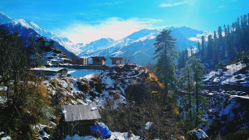 Scenic view of snowcapped mountains against blue sky