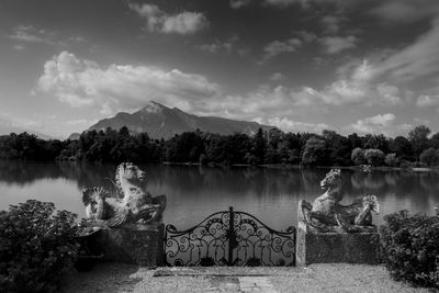 Scenic view of lake by mountain against sky