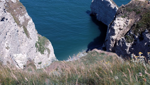 High angle view of rocks by sea