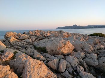 Scenic view of rocky beach against sky