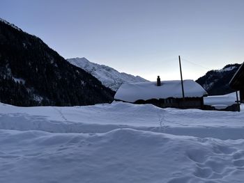 Scenic view of snow covered mountains against sky