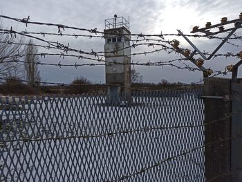 View of barbed wire fence against sky