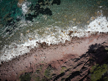 High angle view of water flowing through rocks