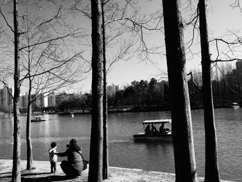 Woman sitting on tree trunk