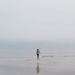 Man standing on beach against sky