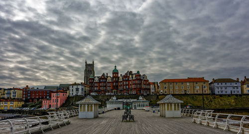 Buildings against cloudy sky