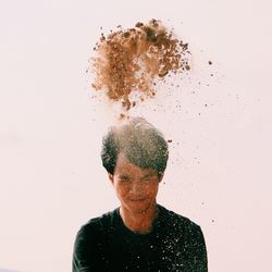 Portrait of young woman against white background