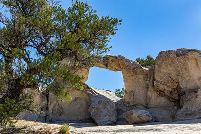 Rock formation against clear blue sky