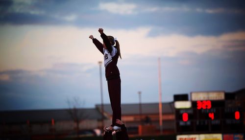 Young man with umbrella standing in background