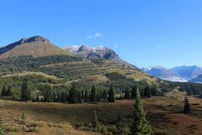 Scenic view of mountains against blue sky