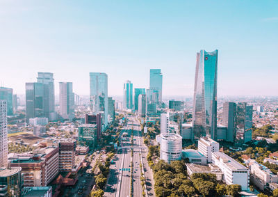 Aerial view of buildings in city against sky