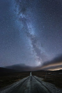 Road against sky at night